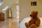 Teddy bear in loft conversion bedroom