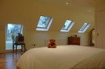 Teddy bear on bed in loft conversion